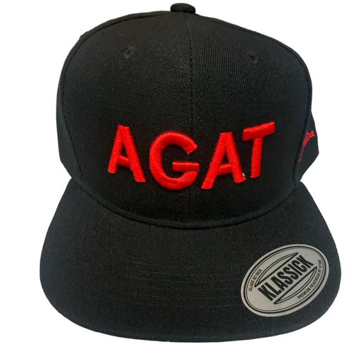 A black flat-brim snapback cap with 'AGAT' embroidered in red across the front panels. A silver oval sticker reading 'CLASSIC' is visible on the brim, and a small red logo is embroidered on the side.