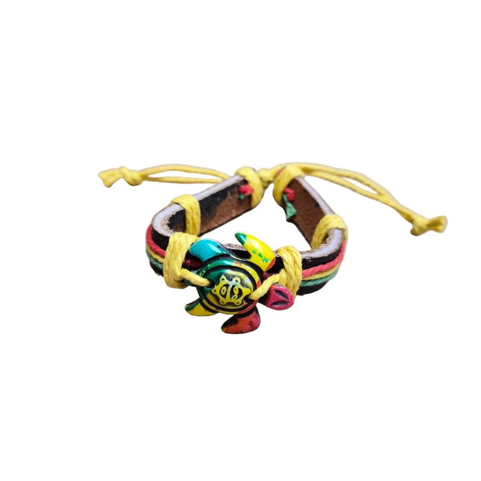 Colorful turtle-shaped bracelet with a yellow cord on a white background