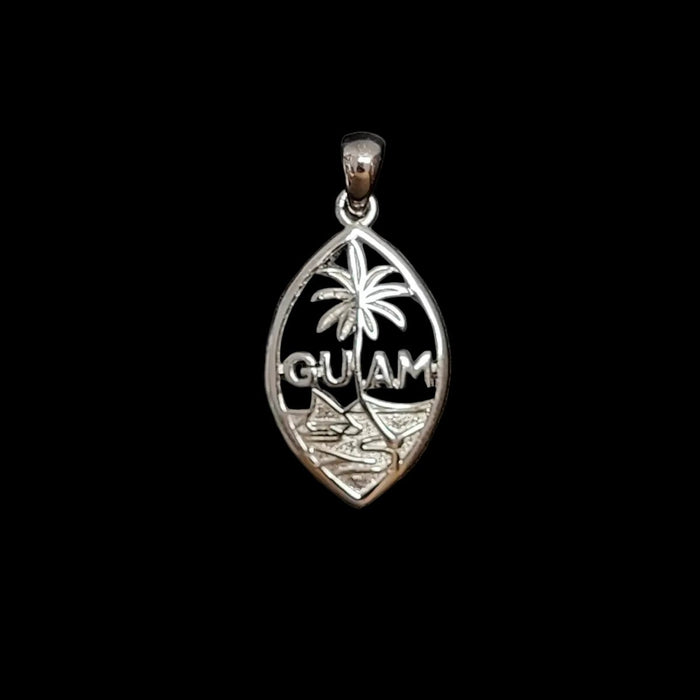 A silver Guam pendant featuring a palm tree and engraved landscape design, displayed on a textured dark gray background.